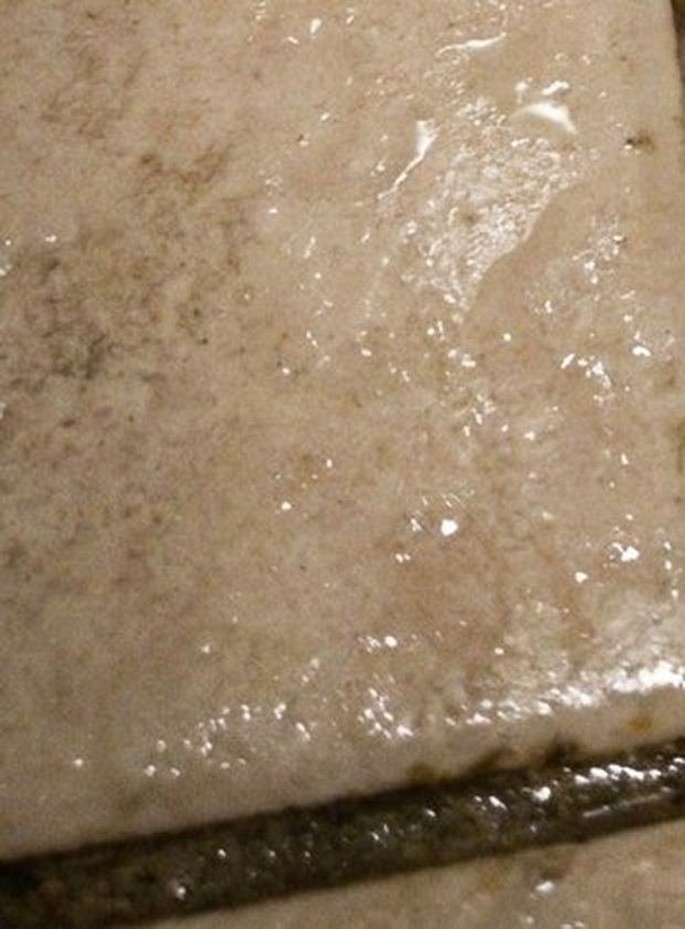 Wet tile on a bathroom floor at night